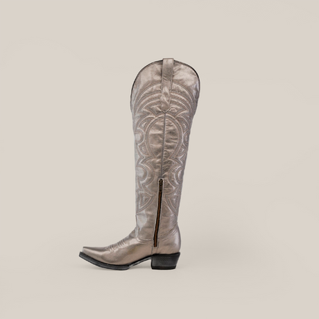 The Taylor Mercury - Tall Shaft - Snip Toe boot, a single silver cowboy boot, stands upright against a plain background. Designed by Taylor Mercury, it has intricate patterns, a low heel, and a durable leather sole.