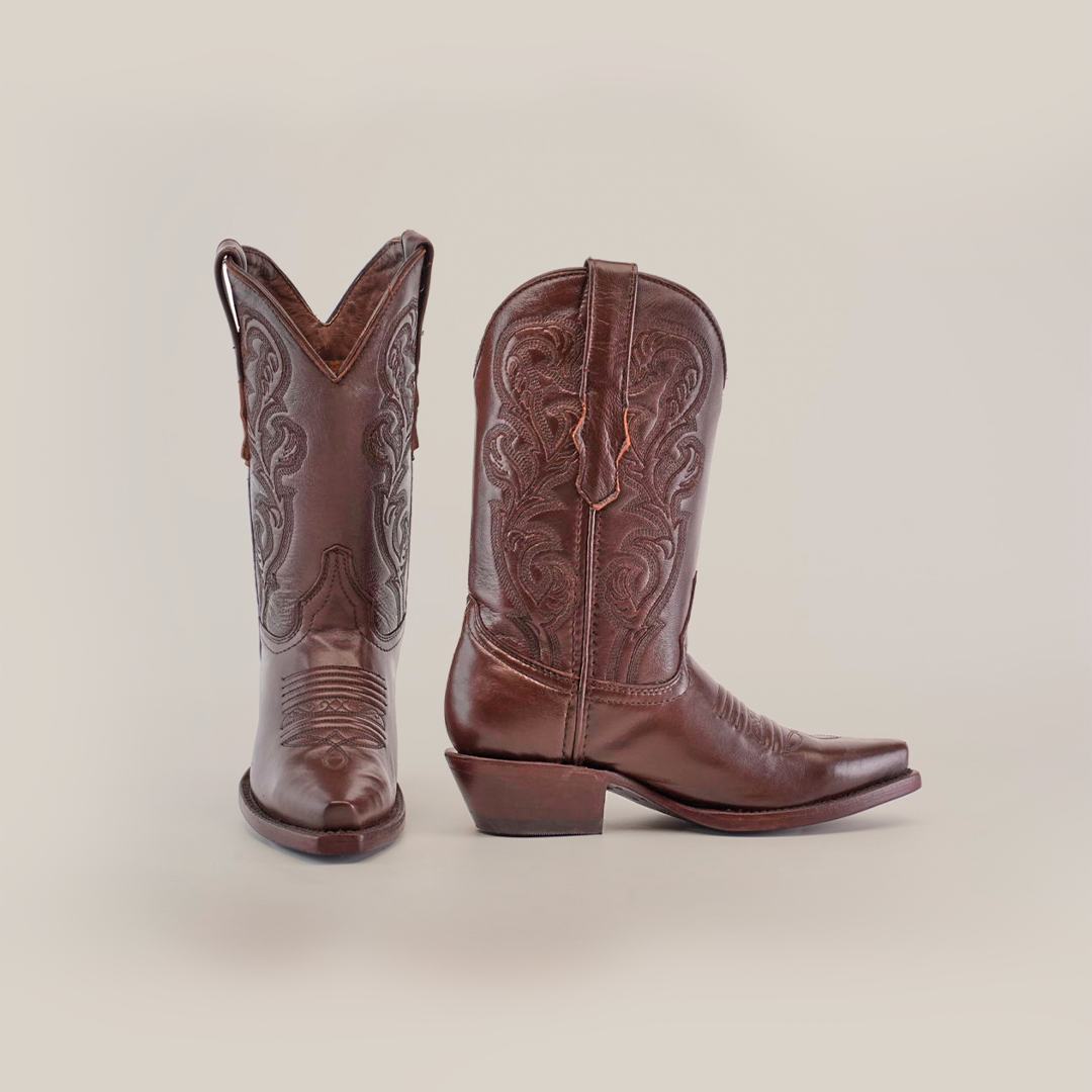 The Plane Jane Moka - Short Shaft - Snip Toe boots are showcased in premium leather; one boot is upright, and the other positioned to reveal heel and side details, encapsulating Western aesthetics on a plain white background.