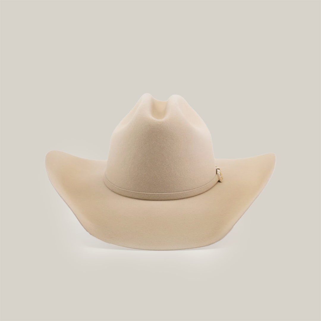 The 100X Tony Lama Belly cowboy hat, a beige symbol of authentic Western elegance, has a wide brim and slightly pinched crown, displayed from the front on a plain white background.