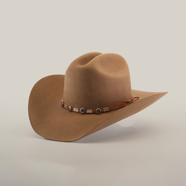 The 6X Country Fawn is a stylish brown felt cowboy hat with a wide brim and a leather band adorned with silver ornaments, displayed on a crisp white background.