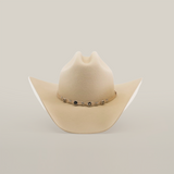 The 6X Country Bone is a Western classic cowboy hat made from premium beige sheep wool felt, featuring a wide brim with a decorative band adorned with small metal accents on a plain white background.