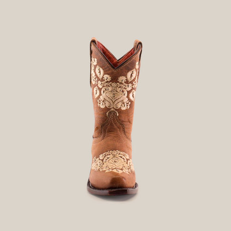 Front view of a Martey Crystals Sahara - Snip Toe cowboy boot in brown, featuring intricate white embroidery and subtle crystal embellishments on the shaft. The boot boasts a pointed toe and slightly arched top, set against a plain white background, exuding elegance and Western charm.