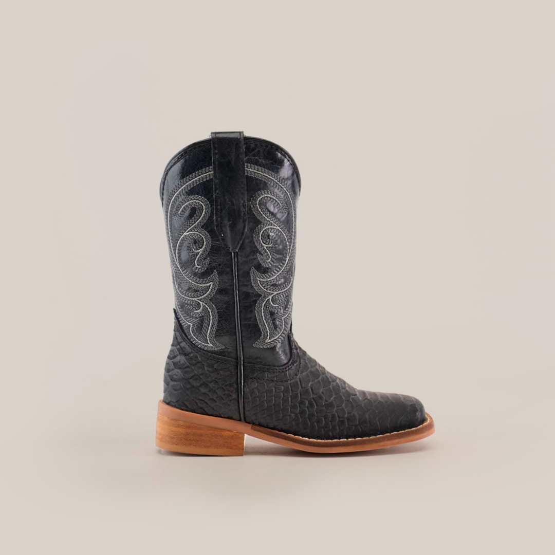 The Python Print Matte Black Square Toe boot is displayed solo against a plain background, featuring cowhide leather with white stitching, a textured pattern, wooden heel, and pointed toe for comfort in every step.