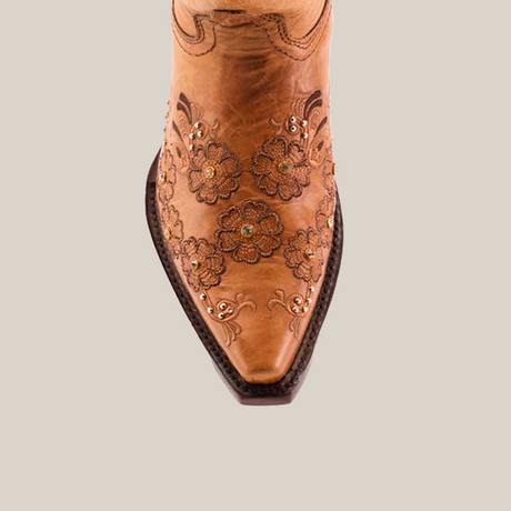 The Florilandia Orix Mid Shaft cowboy boot, featuring a snip toe and floral embossing, is shown front-facing on a white background with black trim at the opening.