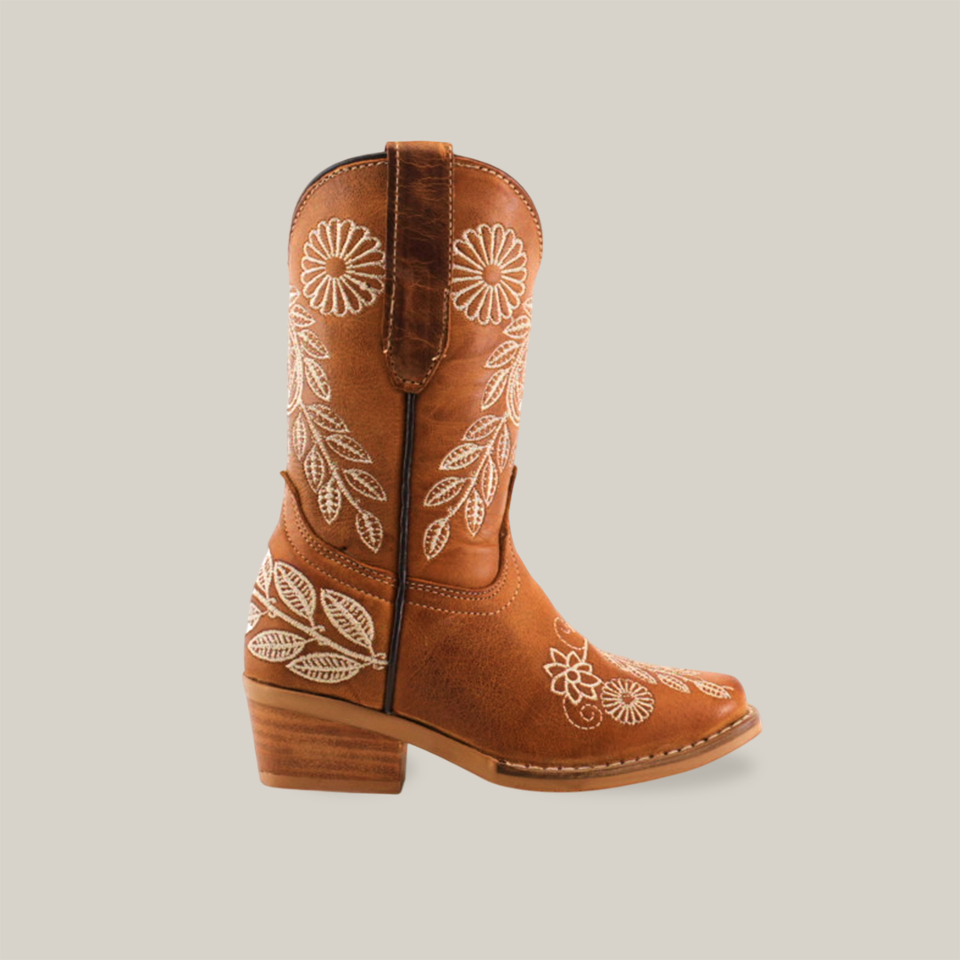 The Rama Honey Snip Toe boots feature white floral embroidery on the shaft and toe, crafted from genuine leather. They include a stacked wooden heel, side pull tabs, and intricate leaf and flower designs for added charm.