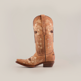 The Marga Cruz Fawn Crystals - Mid Shaft - Snip Toe tan cowboy boot showcases elegant white floral embroidery on the shaft and toe. Made from premium leather, it features a pull tab, rounded pointed toe, and low brown heel against a plain white backdrop.