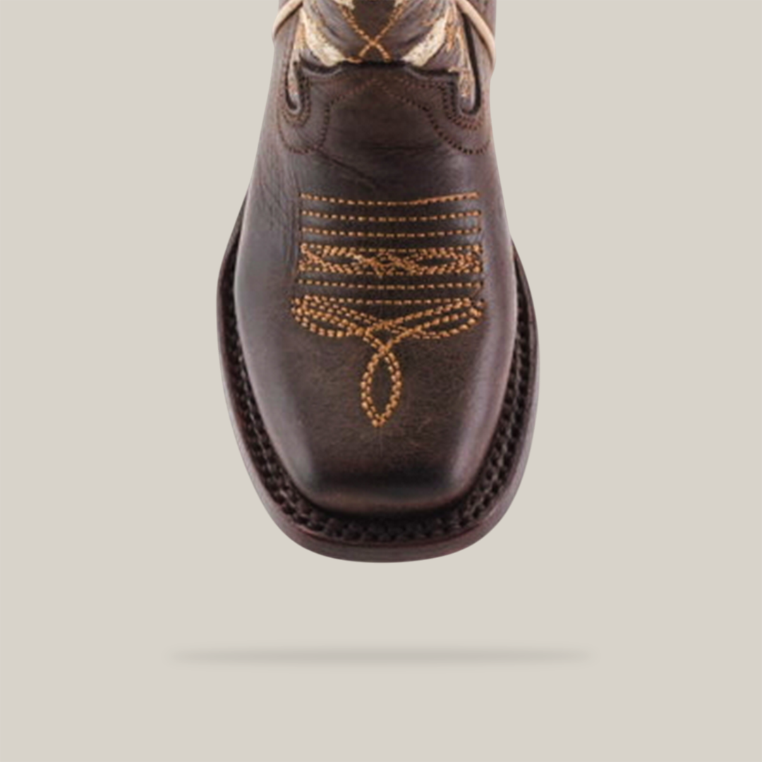 A top view of the Dariela Chocolate cowboy boot reveals intricate tan stitching on the toe. This girls boot features a square toe and a patterned design, crafted from premium chocolate brown leather for lasting elegance.