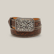 The Ariat Western Girls Belt (Youth Leather, A1303602) features ornate brown leather with intricate floral and studded designs, embodying Western inspiration. Its silver buckle is embellished with swirls and gemstone-like accents. The background is plain off-white.