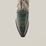 Introducing the Madona Forest Green cowboy boot with a tall shaft, crafted in premium leather and featuring intricate brown stitching on a white background. This handcrafted piece epitomizes style with its snip toe design, showcasing detailed patterns.