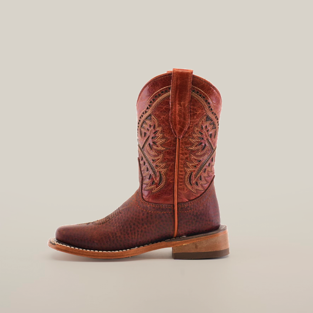 The Cheyenne Shedron Square Toe is a brown cowboy boot crafted from genuine cowhide leather, featuring intricate stitching on the shaft, a handy pull strap, and a solid wooden heel. Its showcased against a plain white background.