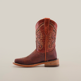 The Cheyenne Shedron Square Toe is a brown cowboy boot crafted from genuine cowhide leather, featuring intricate stitching on the shaft, a handy pull strap, and a solid wooden heel. Its showcased against a plain white background.