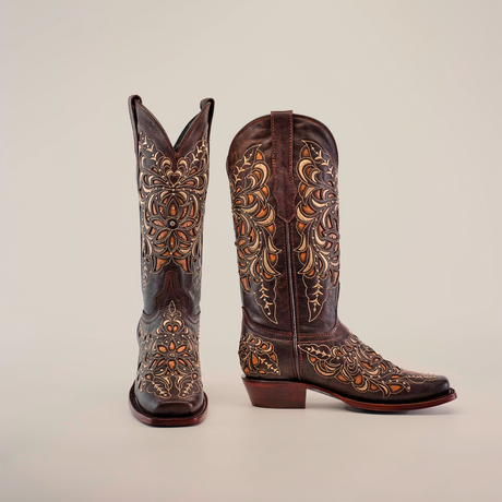 The Kiara Crystals Chocolate Mid Shaft Boots feature intricate brown and gold floral embroidery. Crafted from premium leather, these womens boots have a narrow square toe and a moderately high heel, presented on a plain white background.