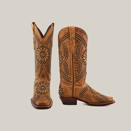 A pair of tall, brown cowboy boots crafted from premium leather with intricate cut-out patterns and Flor Crystal Studs. The left boot is angled to show the side, while the right showcases sturdy heels and a narrow square toe. Product: Flor Crystals Studs - Mid Shaft - Narrow Square Toe.