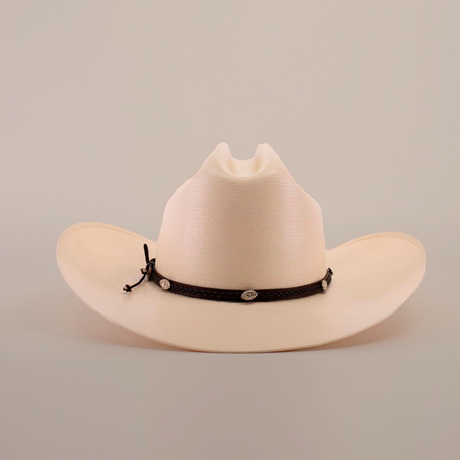 The 1000X Sinaloa Straw Hat boasts a wide brim and black braided band with silver conchos, elegantly set against a simple light backdrop.