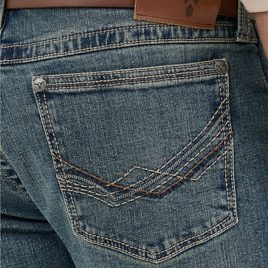 Close-up of the Wrangler Mens 20X Extreme Relaxed Fit Jeans - 1044MWXMA shows a back pocket with decorative stitching, brown leather belt at the waist, and a branded leather patch. These premium denim jeans boast a slightly faded look, offering relaxed fit and ultimate comfort.
