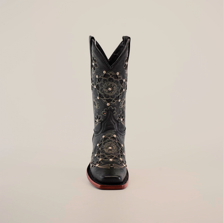 The Mayan Flower Crystals Black boot, featuring a handcrafted design with intricate floral embroidery and a sturdy brown sole, stands upright against a plain white background.