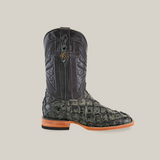 The Exotic Piraruco Fish boot in charcoal features a green and black leather design with crocodile texture and intricate shaft patterns. Ideal for fashion enthusiasts, it has a wooden sole, square toe, slight heel, and is set against a plain white background.