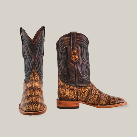 A pair of Gator Print Orix - Square Toe cowboy boots with intricate brown and black patterns, featuring a textured gator print on the foot and smooth cowhide leather on the upper. One boot is upright showing the side, while the other faces forward.