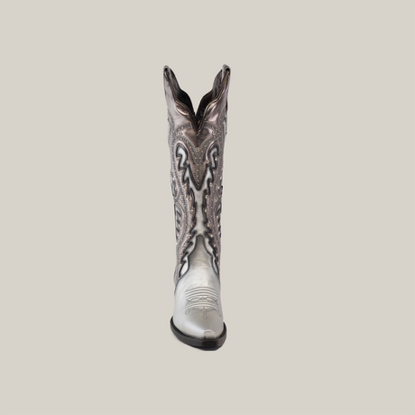 Displayed on a plain white background is a single Valentina Silver - Tall Shaft - Snip Toe cowboy boot. Crafted from premium leather, it boasts intricate black and white patterns with symmetrical swirling lines and decorative stitching, embodying elegance.