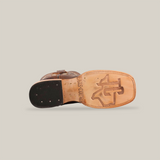 Bottom view of the Bombay Camel - Square Toe boot with a light brown premium cowhide leather sole, embossed branding, and a dark brown heel with metal rivets, featuring a decorative arch pattern.