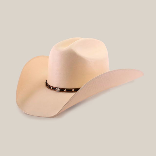 The 1000X Country Straw Hat, shown on a white background, is cream-colored with high-quality materials for exceptional durability. It has a wide brim and a brown band with small decorative elements.