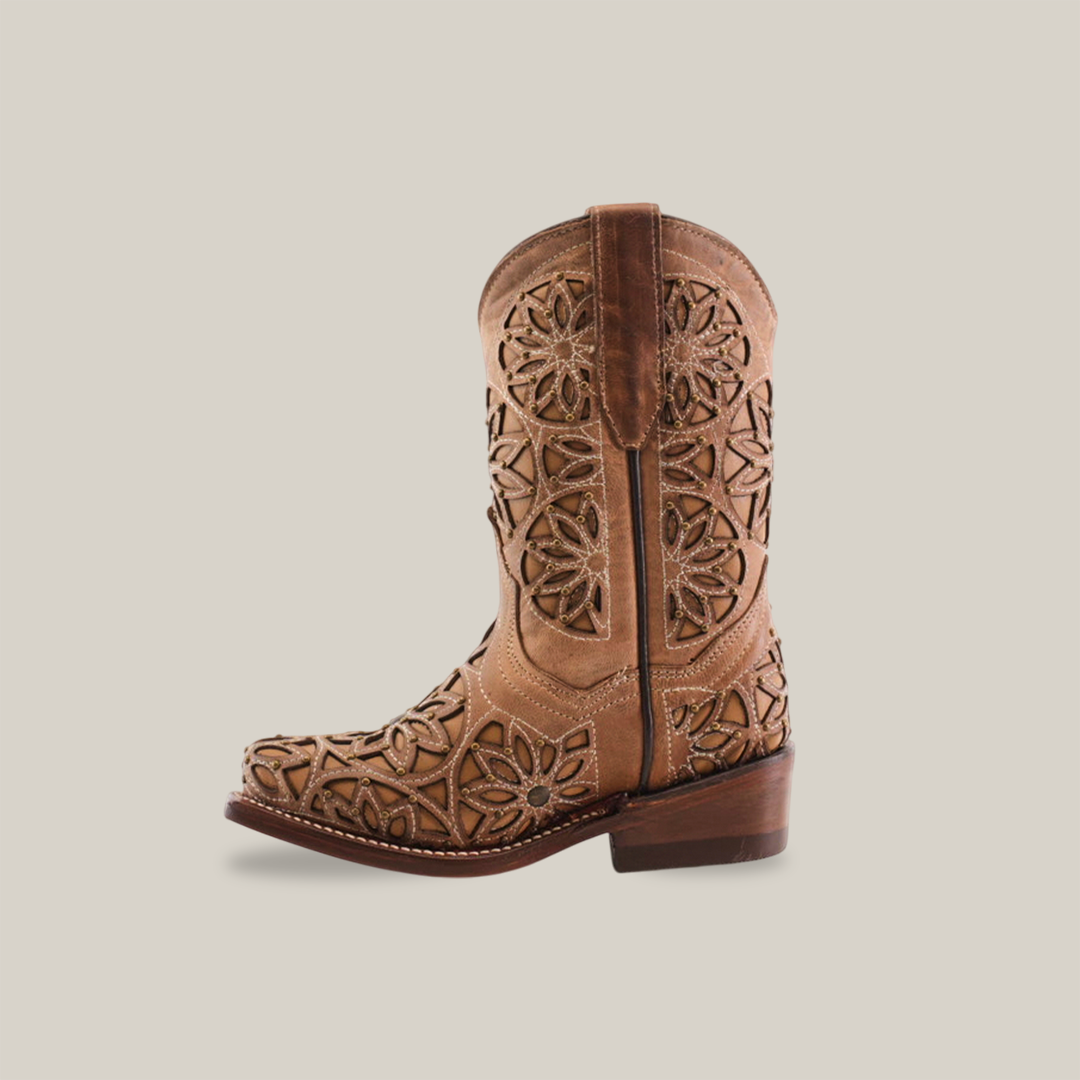 The Vitralli Studs Fawn Snip Toe is a brown cowboy boot featuring intricate cutout floral patterns and decorative stitching. Crafted from premium leather with a classic western heel and medium brown sole, it blends traditional craftsmanship with a modern aesthetic.