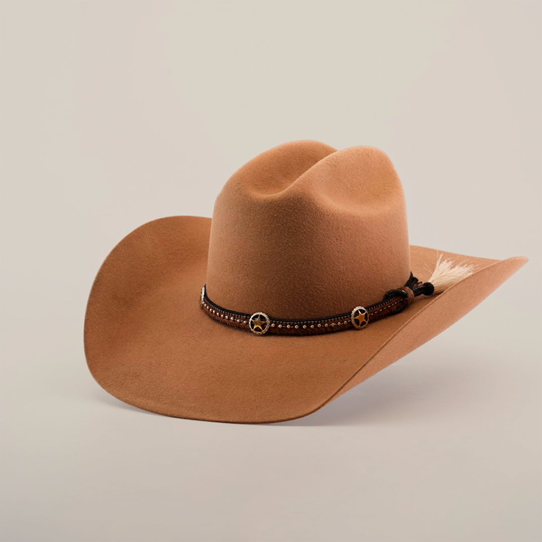 The 6X Doble SS Fawn is a tan cowboy hat made from soft felt, featuring a wide brim, a leather band with star-shaped ornaments, and a small feather, all set against a plain white background.