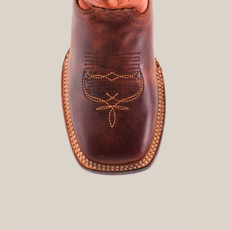 The Azkar Moka Square Toe cowboy boot features a brown leather top view with intricate orange stitching on the toe and a textured sole, showcasing superb craftsmanship and detailed embroidery.