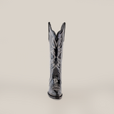 A single Artemisa Patent Black cowboy boot is displayed against a plain background, highlighting its shiny leather, intricate white stitching, tall shaft, and snip toe design.