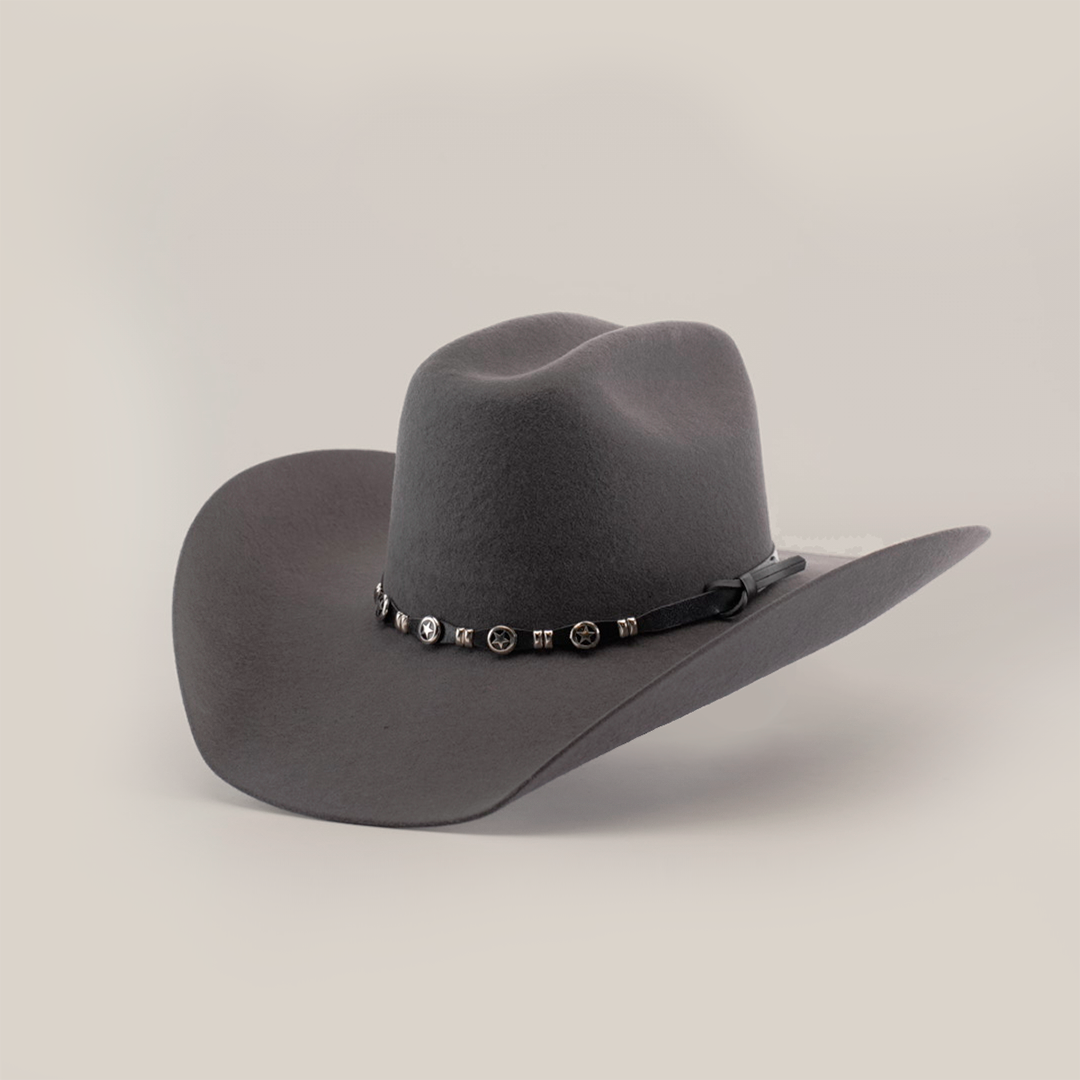 The 6X Bull Oxford, a luxurious gray felt cowboy hat with a wide brim and a decorative band adorned with small round metal accents, is elegantly displayed against a plain white background.