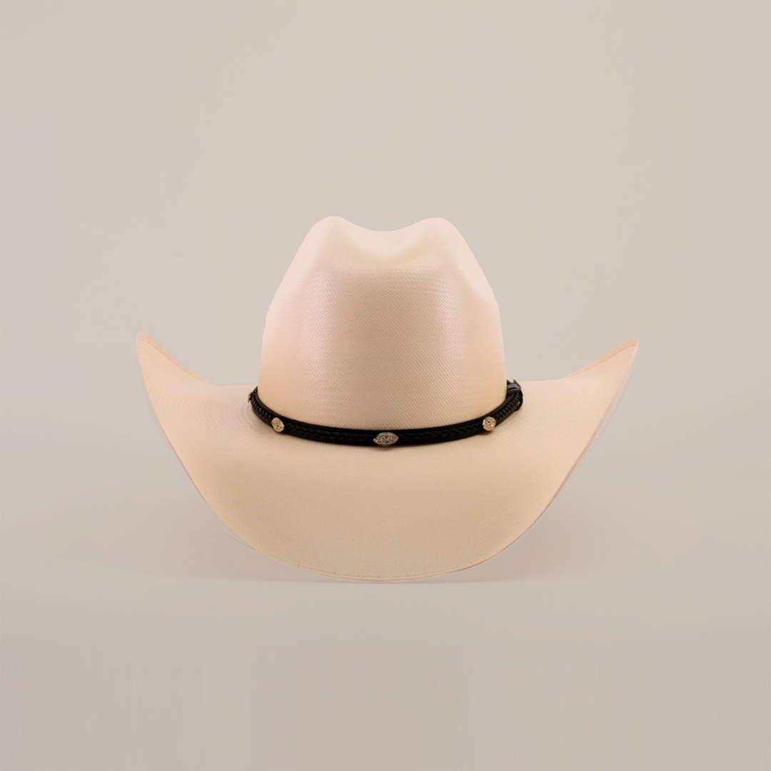 The 1000X Chihuahua Straw Hat, beige with a wide brim and accented by a black band featuring small oval conchos, stands out against a white background, offering a bold fashion statement for those seeking style and durability.