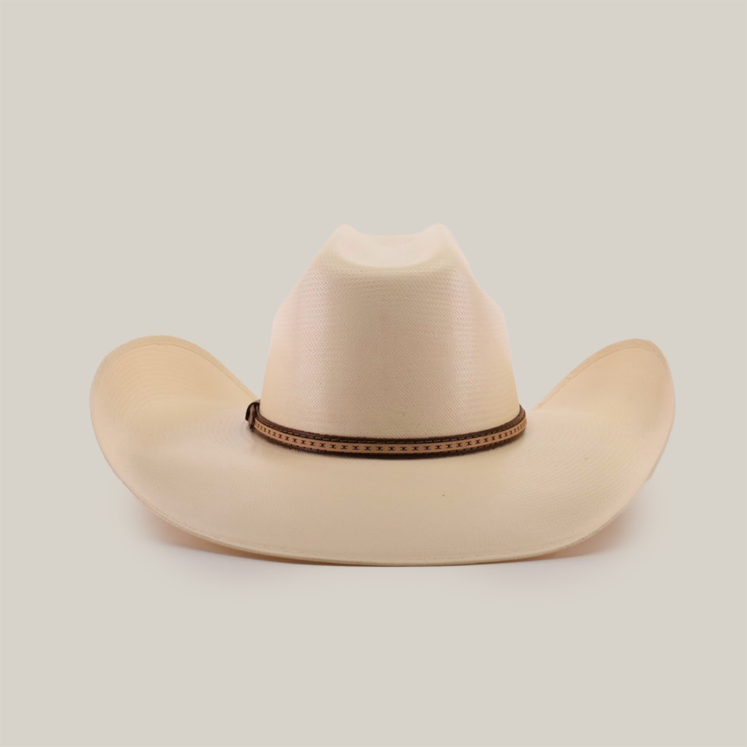 The 1000X Bull Straw Hat features a cream color, wide brim, and brown decorative band around the base of the crown. Its perfect for outdoor adventures, showcasing durability in every stitch against a plain white background.