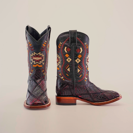 The Exotic American Alligator Patchwork Black Cherry Square Toe boots exude elegance with black leather and multicolored geometric embroidery, featuring diamond and zigzag patterns. A front-facing boot complements a side-on view, highlighting the heel, sole, and a hint of black cherry hue.