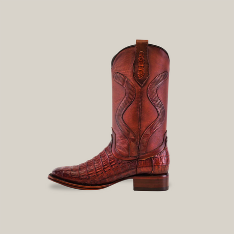 The Exotic Caiman Belly Tail - Diamond - Brandy - Square Toe boot features a brown leather with crocodile pattern, intricate shaft stitching, stacked wooden heel, embossed pull tab, caiman belly texture, and durable Goodyear welt sole.