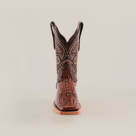 Front view of a single luxury boot, named Caiman Hornback Print Chocolate Square Toe, crafted in brown caiman hornback print with intricate stitching and a pointed toe, set against a pristine white background.