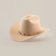 The 6X 2 Carnales Bone is a tan felt cowboy hat made from sheep wool, showcasing a wide brim and a decorative band with metal accents. Small rectangular pieces and a leather string add charm to the band, while the classic western hat rests elegantly on a white background.