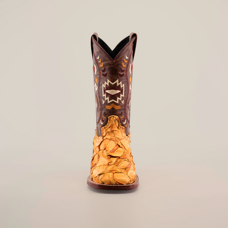 Front view of the Exotic Pirarucu Fish Patchwork Honey Square Toe boot, featuring a brown upper with white and orange geometric embroidery and a tan leather lower part with textured Pirarucu fish scale design against a plain white background.