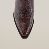 Front view of a Handtooled Flowers Brown Short Shaft boot, showcasing handcrafted elegance with intricate dark stitching on premium leather and a snip toe against a plain white background.