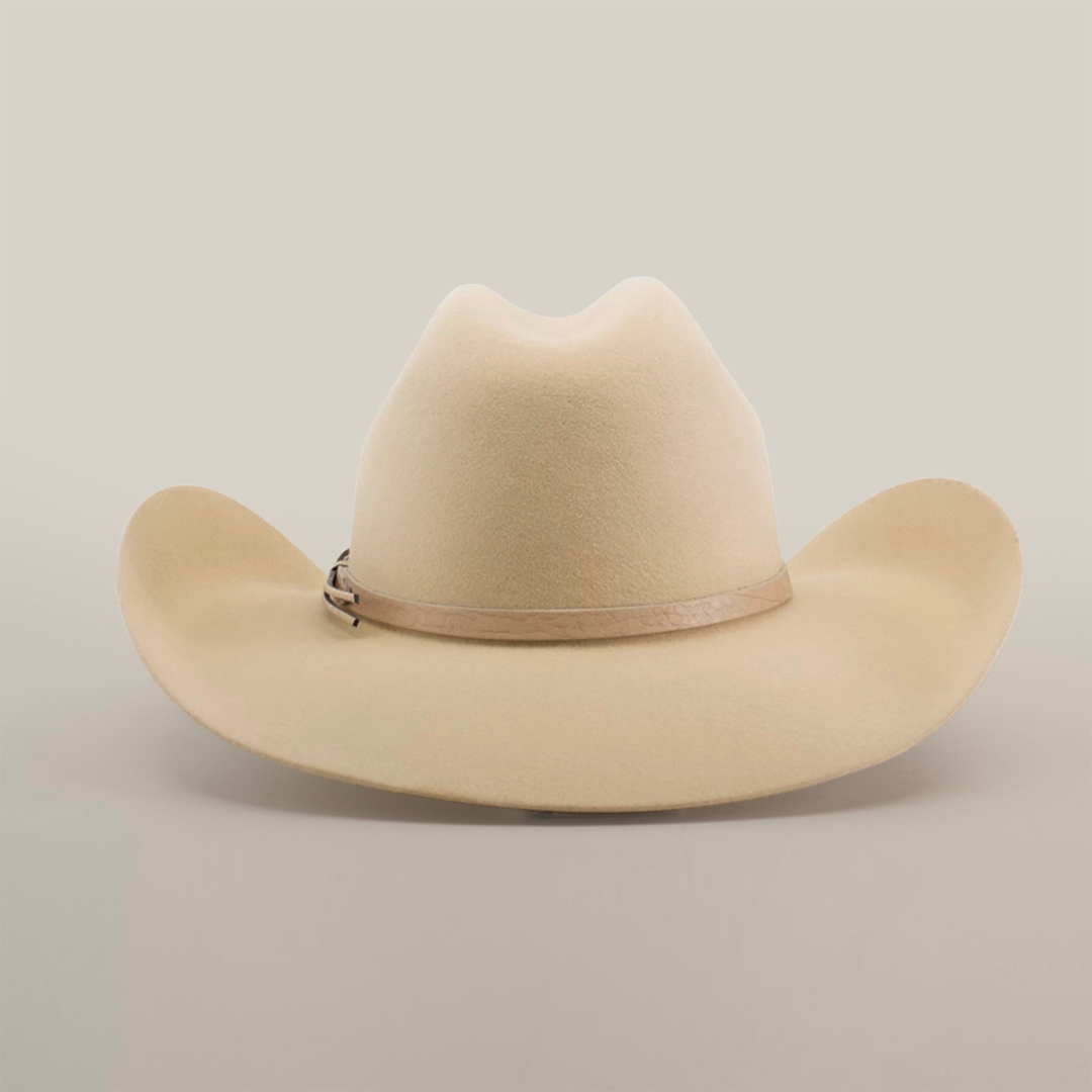 The 6X Chihuahua Bone is a premium Western hat made from Chihuahua felt in a beige tone, featuring a curved brim and light brown band, displayed against a plain white background.