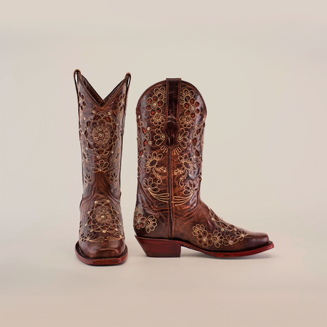 A pair of Mayan Flower Crystals Chocolate Short Shaft Boots, showcasing intricate floral embroidery, is set against a plain white background. One boot stands upright while the other is angled to highlight its exquisite handcrafted details.