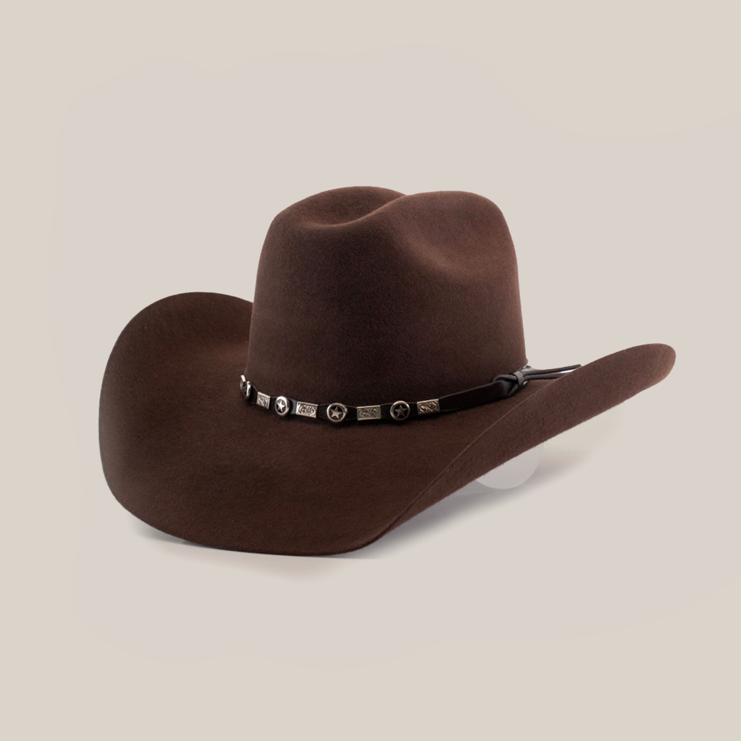 The 6X Bull Brown is a premium felt cowboy hat featuring a wide brim and a decorative band with metal conchos, ideal for enhancing your luxury western wear ensemble.