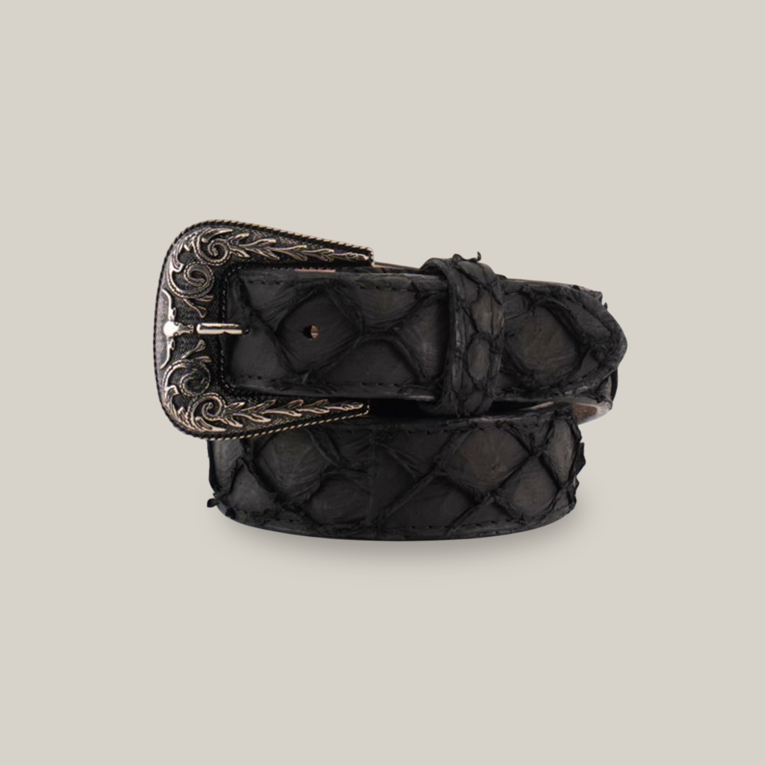 The Exotic Full Quilt Pirarucu Fish - Texas Buckle in matte black, crafted from genuine scales with a textured pattern and ornate engraved silver buckle, is displayed coiled neatly on a plain white background.