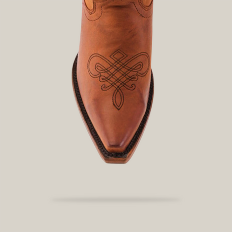 Close-up of the Miriam Brick Tall Shaft Snip Toe cowboy boot, crafted from premium materials, featuring intricate embroidery on the snip toe and dark stitching on the sole. The background is plain white.