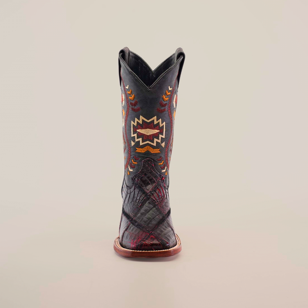 Front view of an Exotic American Alligator Patchwork Black Cherry Square Toe cowboy boot, featuring a black upper with colorful geometric embroidery in orange, red, and yellow hues, and a brown sole that boldly contrasts the textured leather.