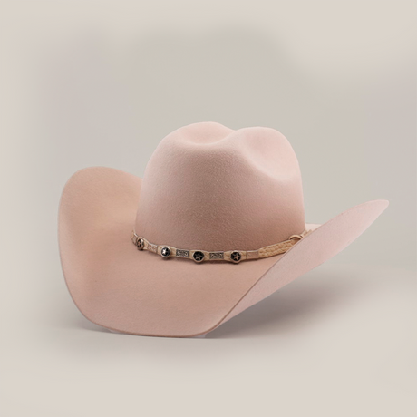 The 6X Bull Belly, a beige western hat with a wide brim and a decorative band with metallic embellishments, stands against a plain white background, epitomizing luxury western wear.