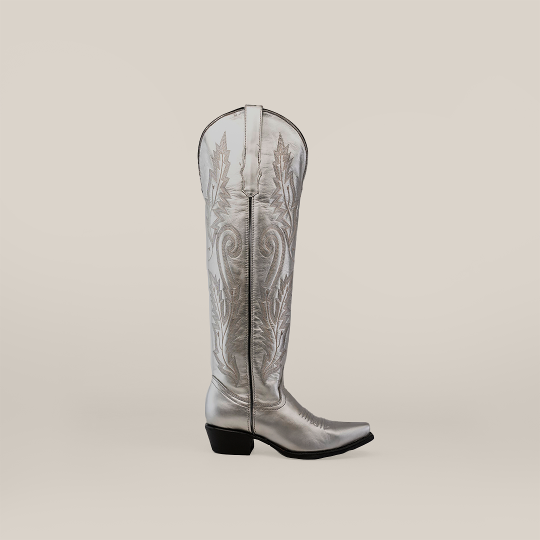 The Brittany Silver-Tall Shaft-Snip Toe Boot combines premium leather with western-style embroidery in its handcrafted design. This silver boot features a snip toe, low heel, side zipper closure, and stands out elegantly against a plain, light background.