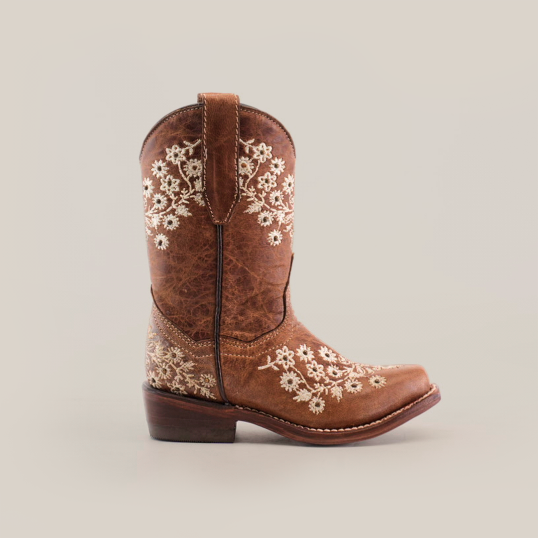 The Abril Studs Orix Snip Toe is a single brown cowboy boot with detailed white floral embroidery on the shaft and foot, showcasing a snip toe design, set against a plain white background.