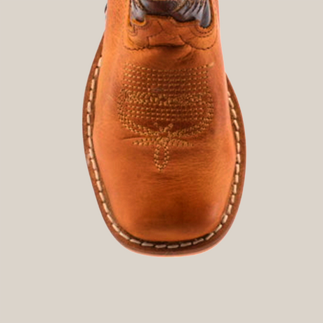 Top view of the handcrafted Cater Honey Square Toe boot, featuring intricate stitching on the cowhide leather with a square toe shape and a decorative pattern. A visible sole with a white stitch outline completes its refined look.