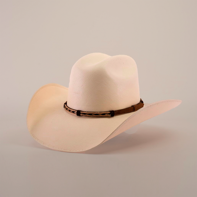 The 5000x Chihuahua Straw Hat, featuring a cream color, wide brim, and brown band, showcases exquisite craftsmanship as it sits angled on a white surface.