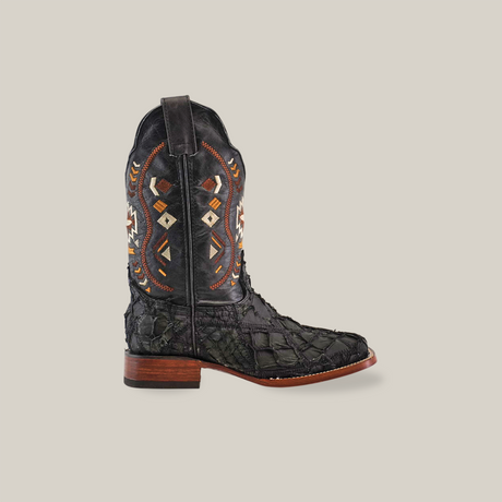 The Exotic Pirarucu Fish Patchwork Matte Black Square Toe features a single cowboy boot made from authentic leather, with a dark texture and intricate geometric patterns in rust, white, and orange. It includes a wooden heel and decorative pull strap for easy wear.